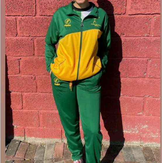 Student in a green and gold tracksuit